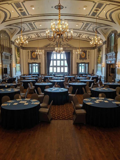 Untitled The Tudor Arms Hotel ballroom set up for an event with blue tablecloths.