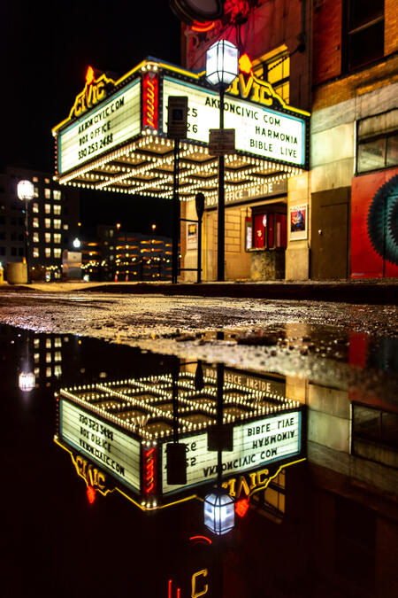 Untitled The Akron Civic Theatre at night with a reflection of the marquee in a puddle.