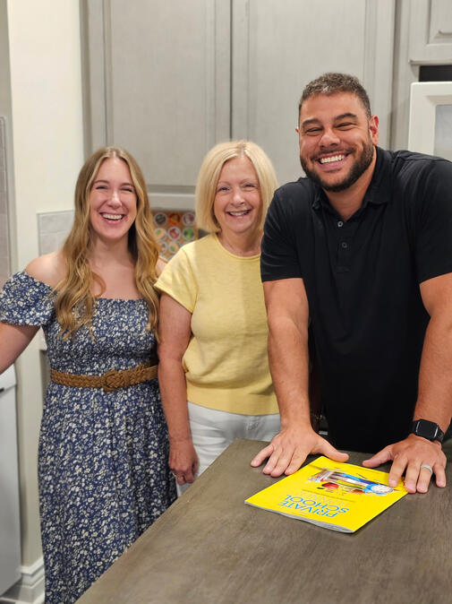 Untitled Shane Shannon smiling and leaning on a kitchen counter with Kathy Archer and Sarah Jobin Spaller next to him.